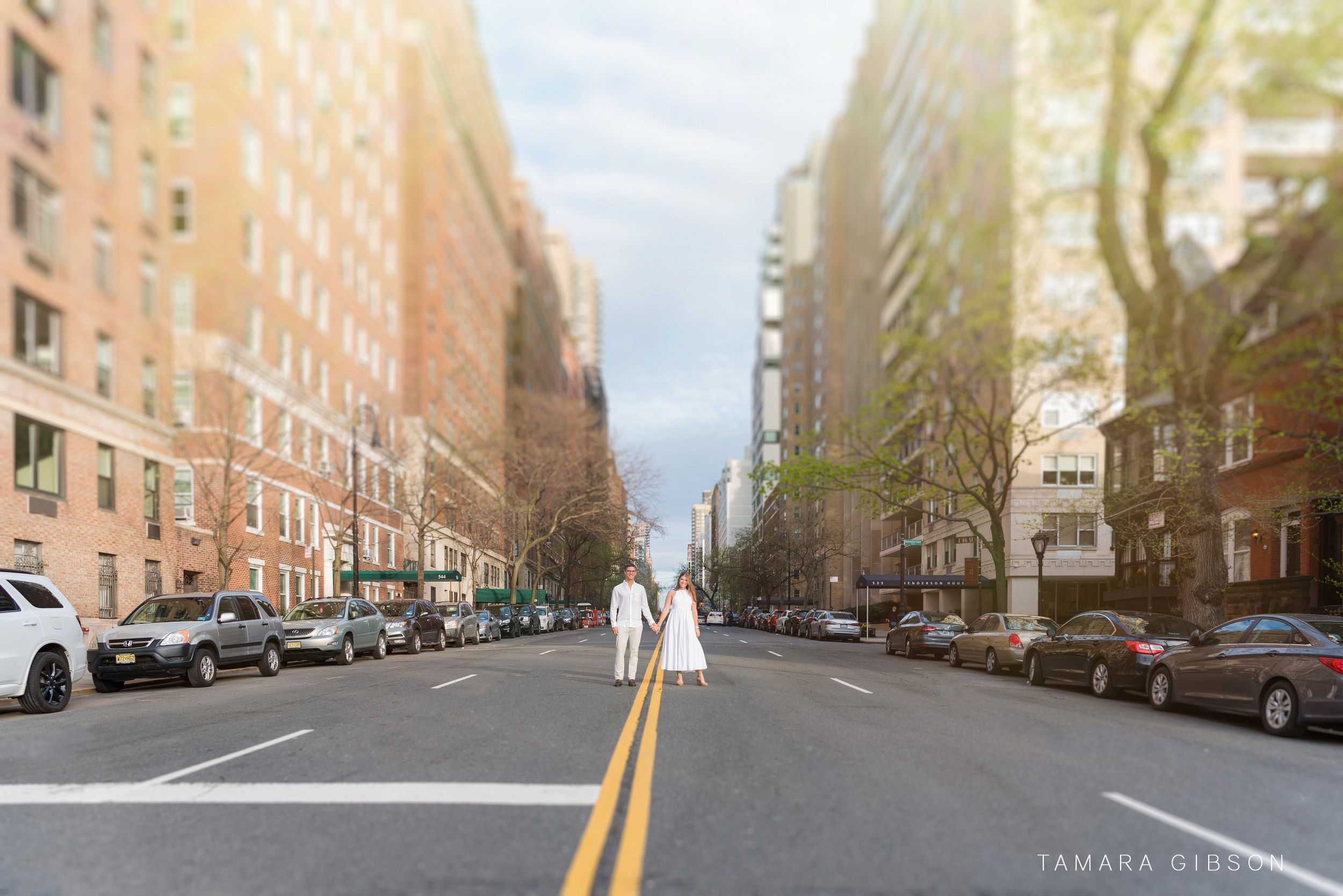 Couple holding hands in empty street during NYC Engagement Session