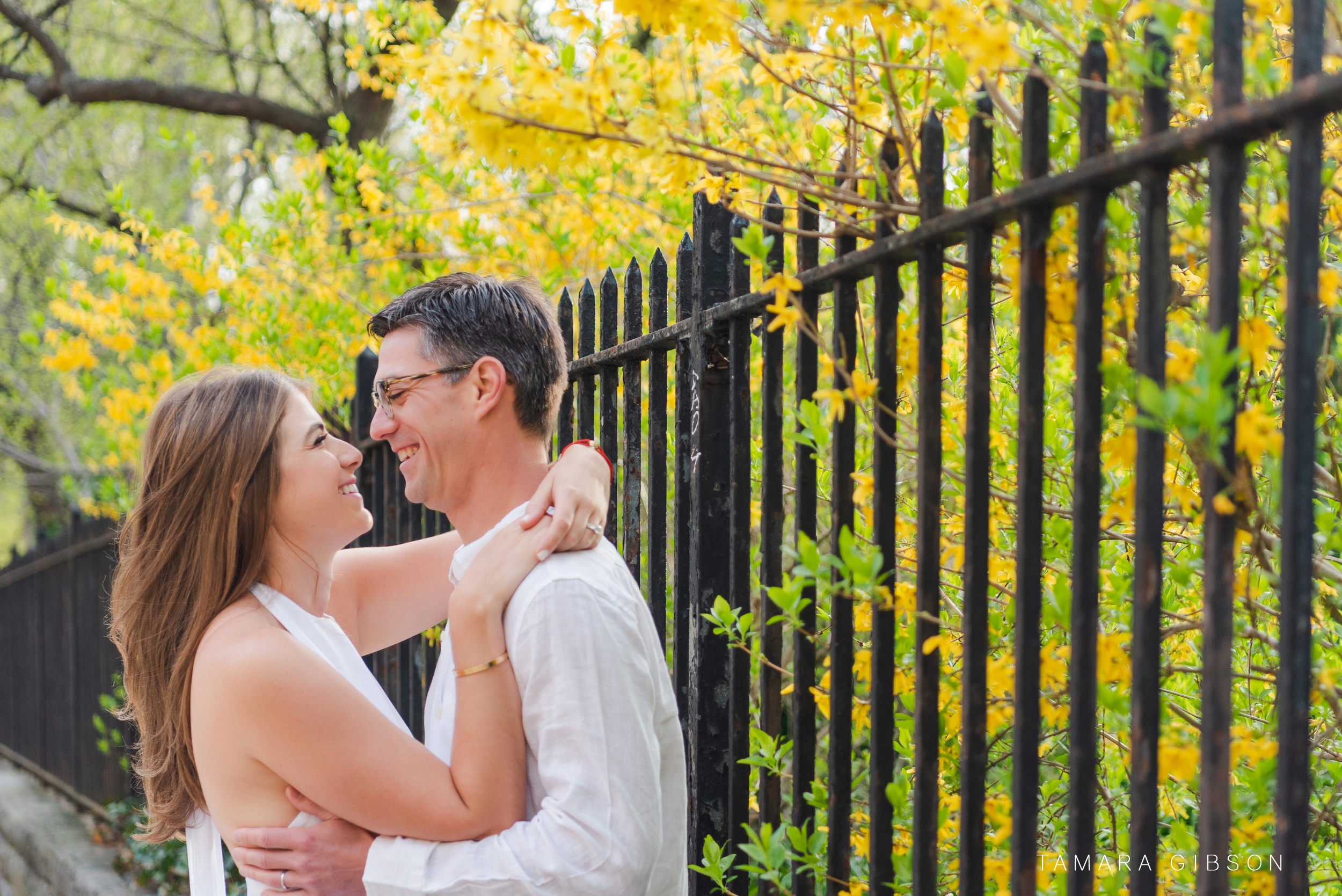 Couple in front of iron fence