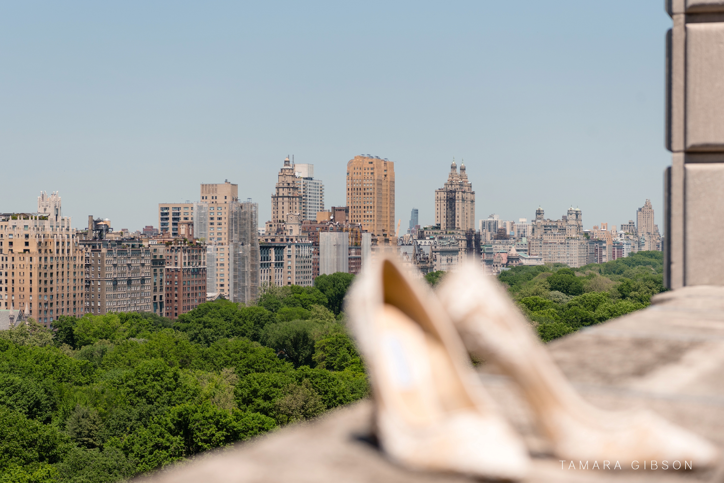Detail shot of NYC skyline during wedding, brides shoes in the foreground