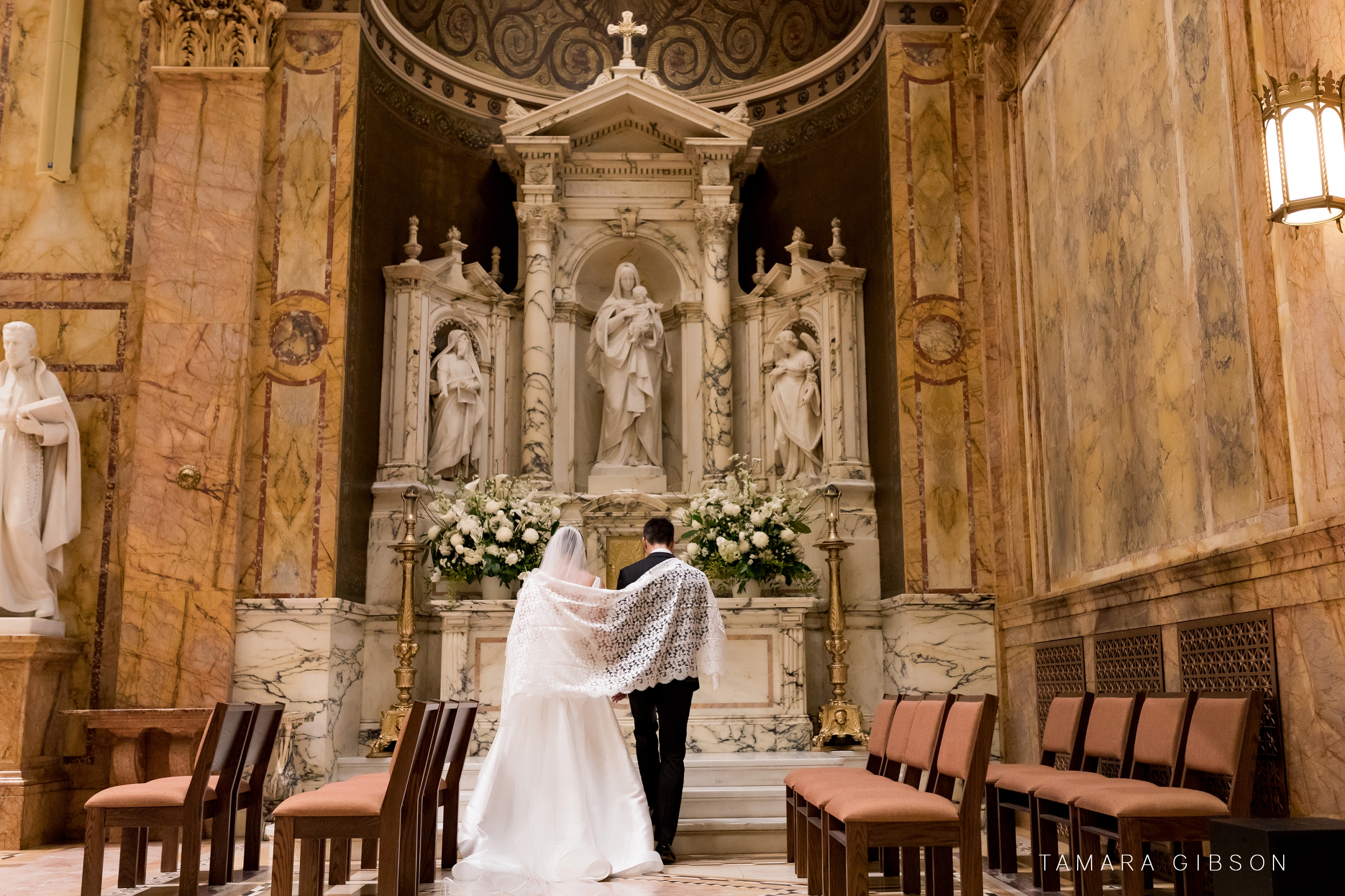Victoria and Thomas with shawl in front of Virgin Mary during NYC Wedding 