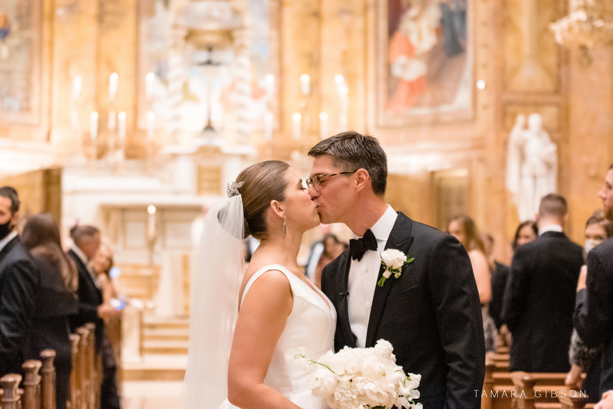 Victoria and Thomas kissing inside St. Ignatius of Loyola Church