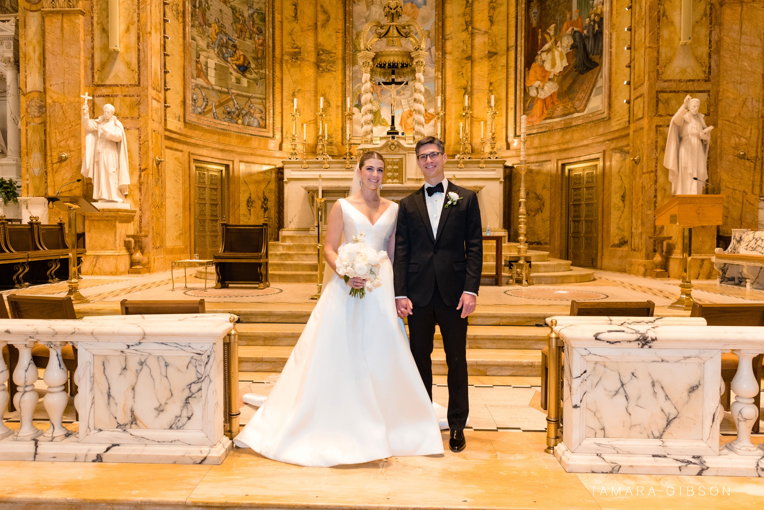 Victoria and Thomas in front of St. Ignatius of Loyola altar during NYC wedding