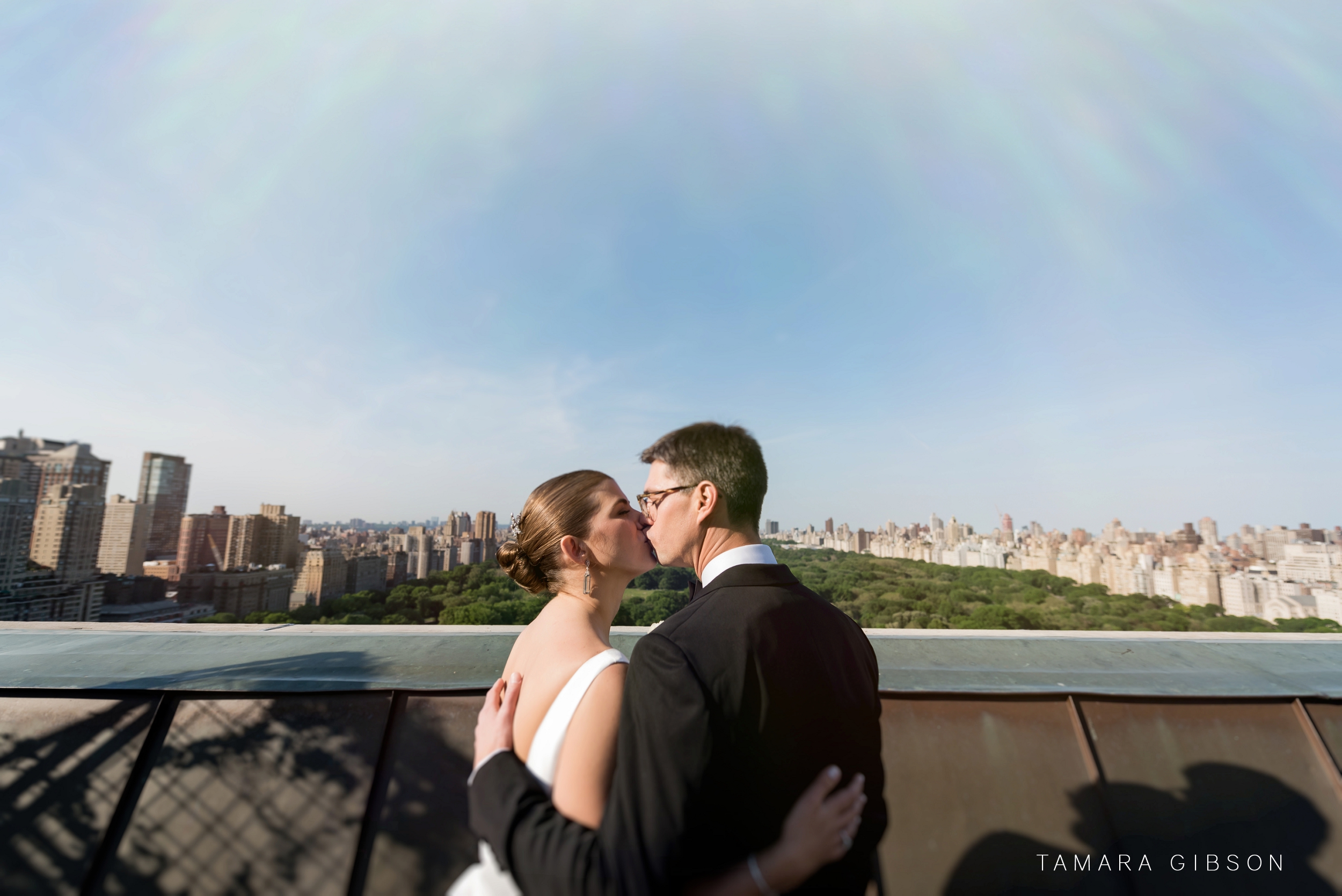 Thomas and Victoria share a kiss overlooking central park at NYC Wedding
